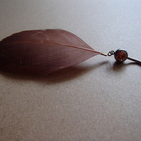Real feather, peach belly navel ring.