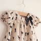 Deer_dress_close_up_of_boat_neck_o_neck_and_bow_plus_print_small